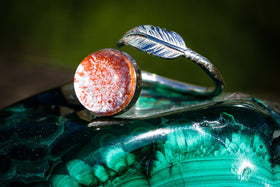 silver ring with feather and glass cabochon