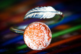 silver ring with feather and glass cabochon