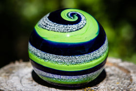 blue and green glass orb with cremation ash