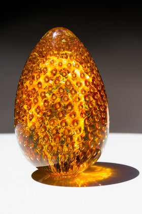 Solid Glass Cremation Urn with Infused Cremains - Topaz Bubble Egg