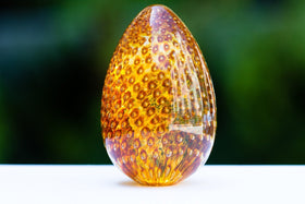 solid-glass-cremation-urn-with-infused-cremains-topaz-bubble-egg